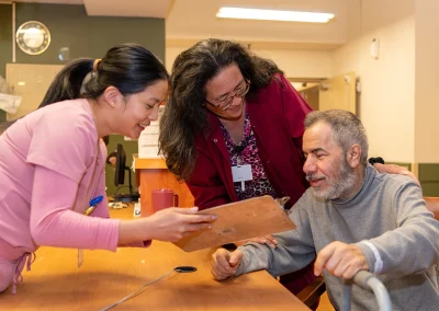 Two rehab therapists with a resident in the rehab gym at Grant Cuesta Sub-acute and Rehab