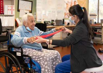 A rehab therapist with a resident in the rehab gym at Grant Cuesta Sub-acute and Rehab